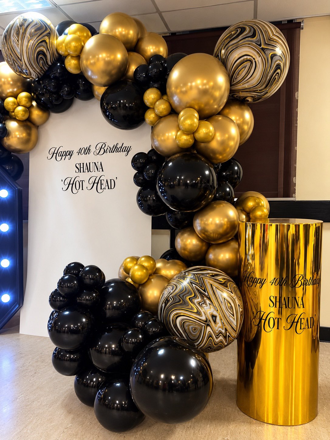 Black and gold birthday balloon display