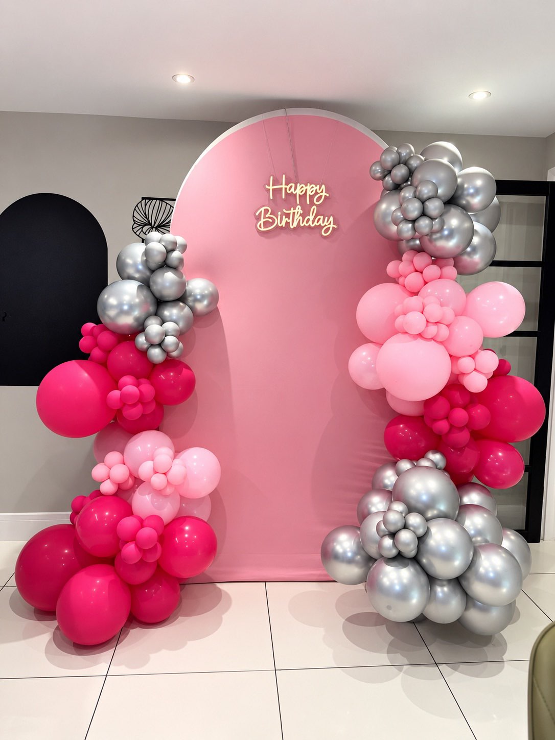 Pink birthday backdrop with pink and silver balloons